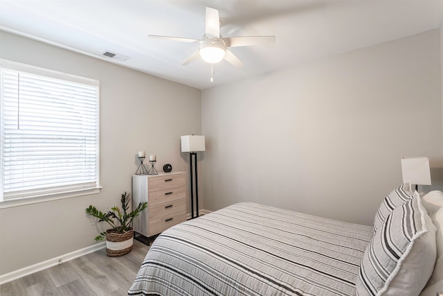 bedroom with light hardwood / wood-style floors and ceiling fan