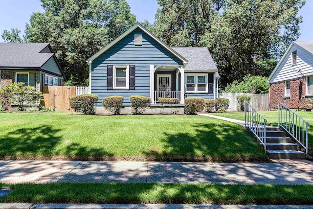 bungalow-style house featuring a front lawn