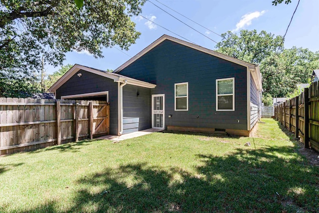 rear view of property featuring a yard