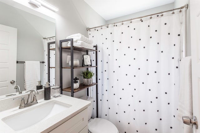 bathroom featuring vanity, toilet, and a shower with curtain