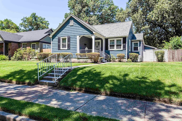 view of front of house featuring a front lawn and covered porch