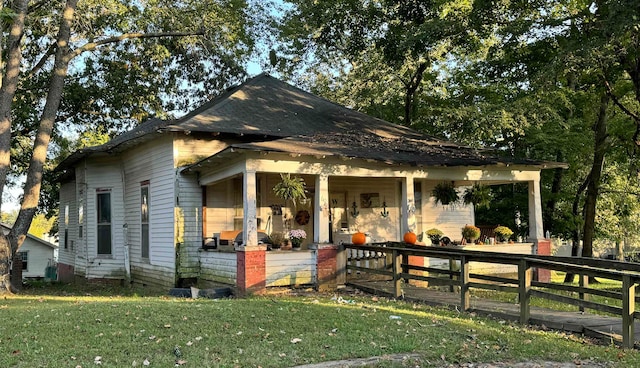 bungalow-style house with a front yard and a porch