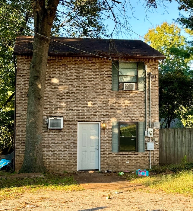 rear view of house featuring cooling unit