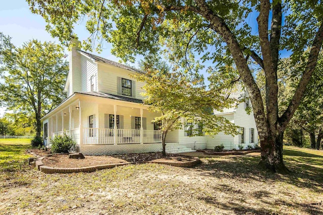 view of side of home featuring a porch