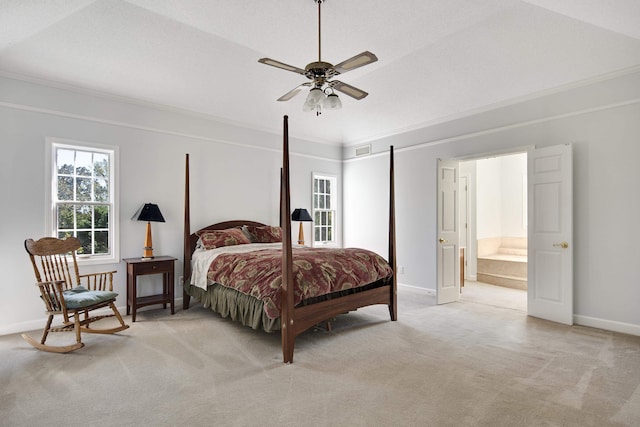 bedroom featuring light carpet, ensuite bathroom, ceiling fan, a textured ceiling, and crown molding