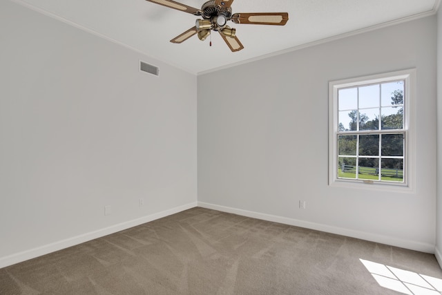 carpeted empty room featuring ceiling fan and crown molding