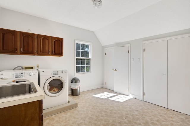 laundry area featuring cabinets, sink, and separate washer and dryer