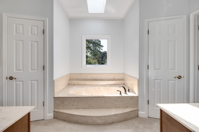 bathroom featuring a bath, vanity, a skylight, and crown molding