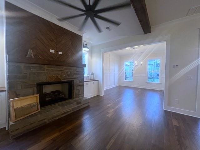 unfurnished living room featuring beam ceiling, a fireplace, dark hardwood / wood-style flooring, and ornamental molding