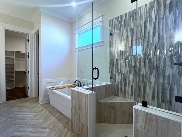 bathroom featuring parquet flooring, tile walls, and independent shower and bath