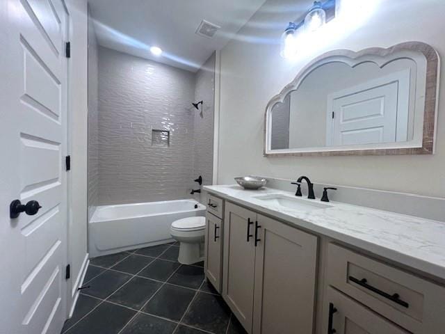 full bathroom with toilet, tile patterned flooring, vanity, and tiled shower / bath