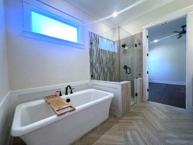 bathroom with separate shower and tub, parquet floors, and ornamental molding