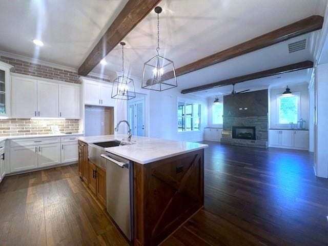 kitchen featuring dishwasher, white cabinets, a center island with sink, beam ceiling, and dark hardwood / wood-style flooring