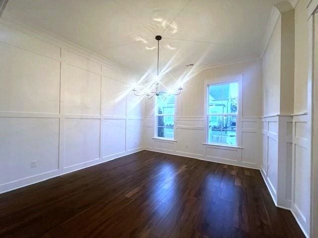 additional living space with a chandelier and dark wood-type flooring