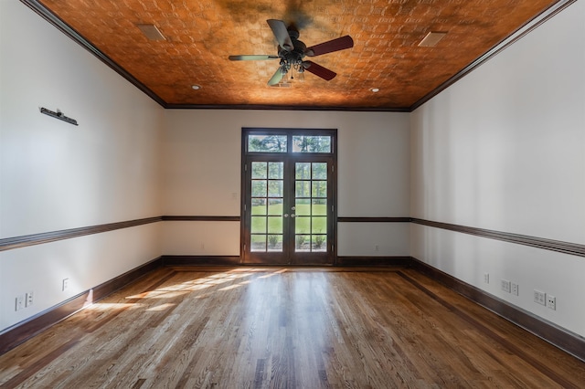 unfurnished room featuring french doors, crown molding, hardwood / wood-style floors, and brick ceiling