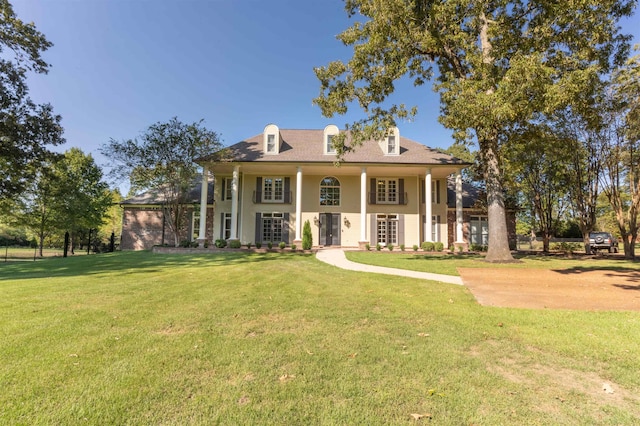 view of front of house with a porch and a front lawn