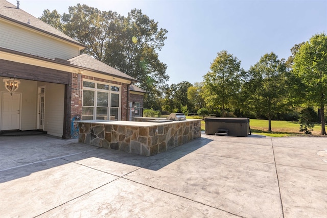 view of patio / terrace with a hot tub