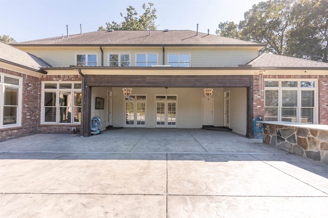 rear view of property featuring french doors and a patio area