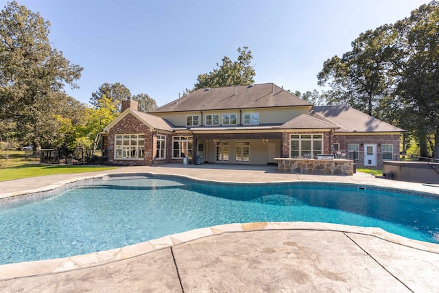 view of pool featuring french doors, a patio, and a hot tub