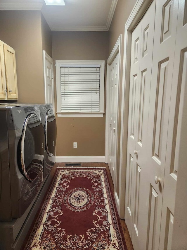 washroom with ornamental molding, cabinets, separate washer and dryer, and dark hardwood / wood-style floors