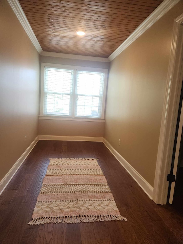 unfurnished room with ornamental molding, wooden ceiling, and dark hardwood / wood-style flooring