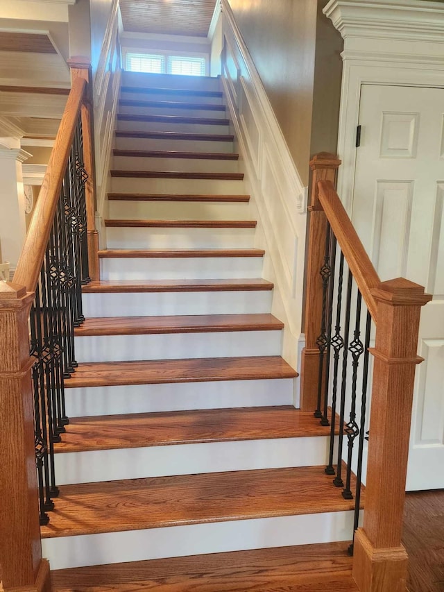 stairs featuring hardwood / wood-style flooring and crown molding