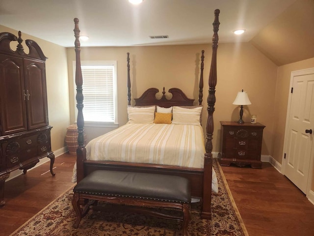 bedroom with lofted ceiling and dark hardwood / wood-style flooring