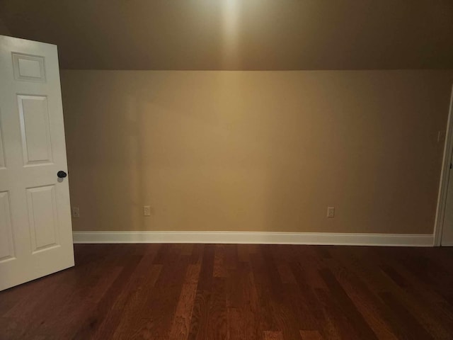 bonus room with dark wood-type flooring