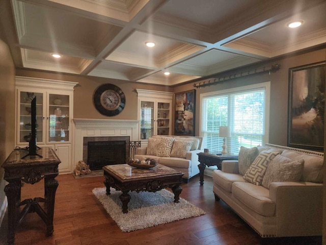 living room featuring coffered ceiling, crown molding, and dark hardwood / wood-style flooring