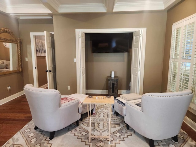 living area with beamed ceiling, crown molding, and hardwood / wood-style floors