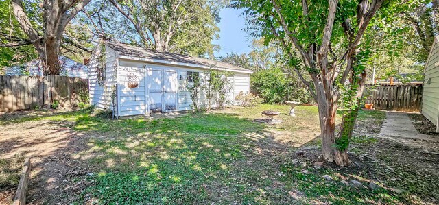 view of yard featuring a fire pit and a storage unit