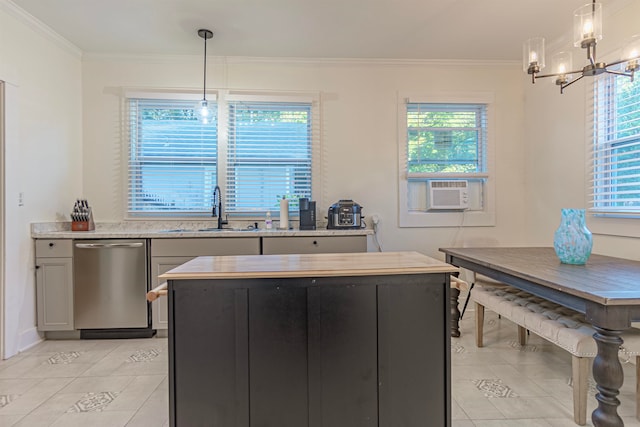 kitchen with a healthy amount of sunlight, sink, decorative light fixtures, and stainless steel dishwasher