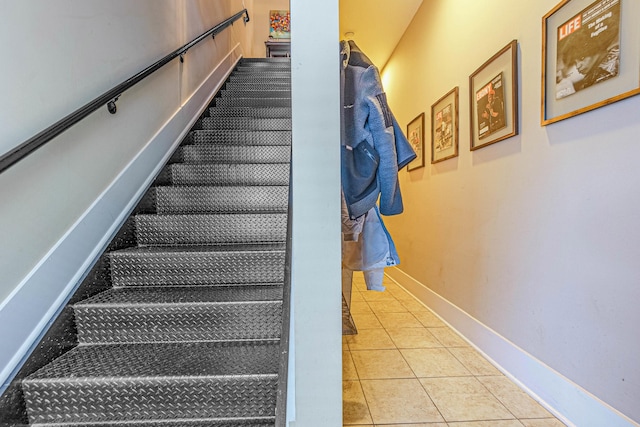 staircase featuring tile patterned flooring