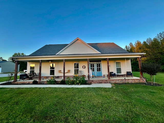 country-style home with a porch and a front lawn