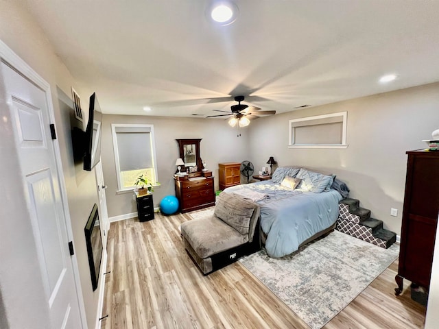 bedroom with light hardwood / wood-style floors and ceiling fan