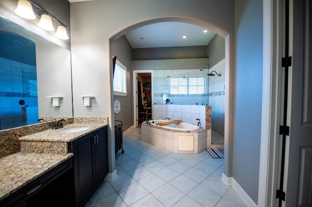 bathroom with tile patterned flooring, separate shower and tub, and vanity