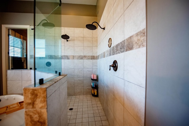 bathroom with a tile shower and tile walls