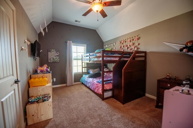 bedroom with ceiling fan, lofted ceiling, and carpet flooring