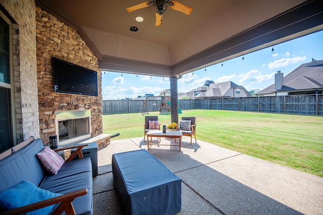 view of patio / terrace with an outdoor stone fireplace and ceiling fan