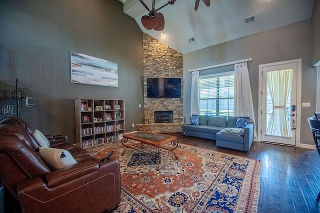 living room featuring a stone fireplace, high vaulted ceiling, hardwood / wood-style floors, and ceiling fan