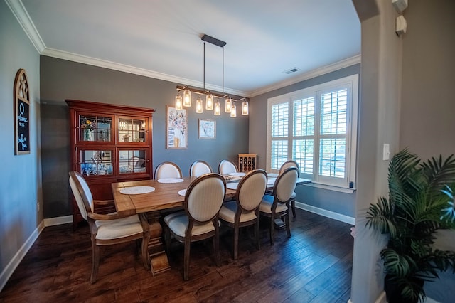 dining room with ornamental molding and dark wood-type flooring