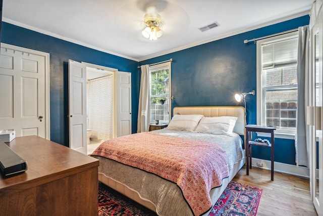 bedroom with crown molding, ceiling fan, and hardwood / wood-style floors