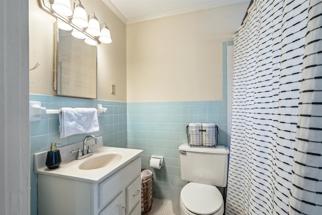 bathroom with tile patterned flooring, toilet, crown molding, tile walls, and vanity