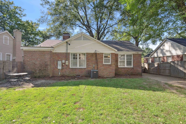 back of property featuring a yard and a patio