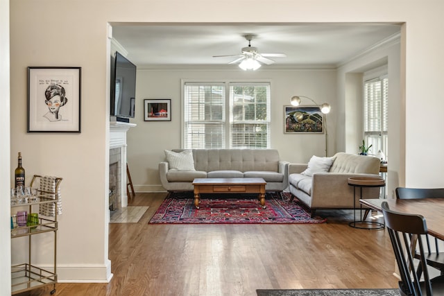 living room with hardwood / wood-style flooring, plenty of natural light, and crown molding