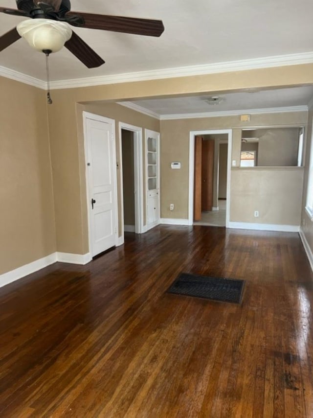 unfurnished room with dark wood-type flooring, built in features, ornamental molding, and ceiling fan