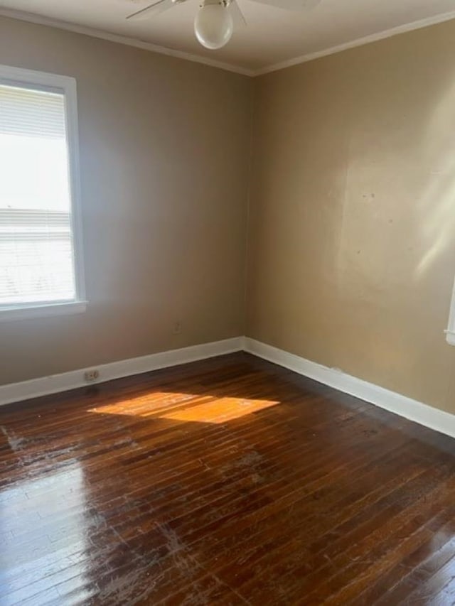 spare room featuring dark hardwood / wood-style floors, crown molding, and ceiling fan