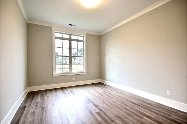 spare room with ornamental molding and wood-type flooring