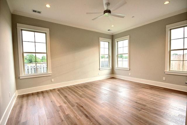 spare room featuring light hardwood / wood-style floors, crown molding, and ceiling fan