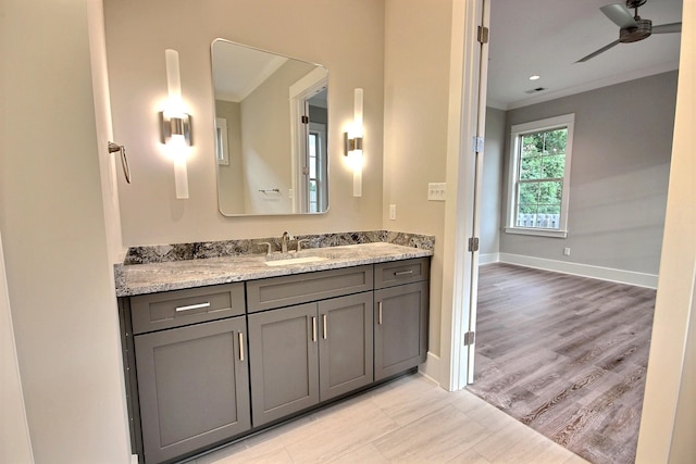 bathroom featuring hardwood / wood-style flooring, ceiling fan, and vanity